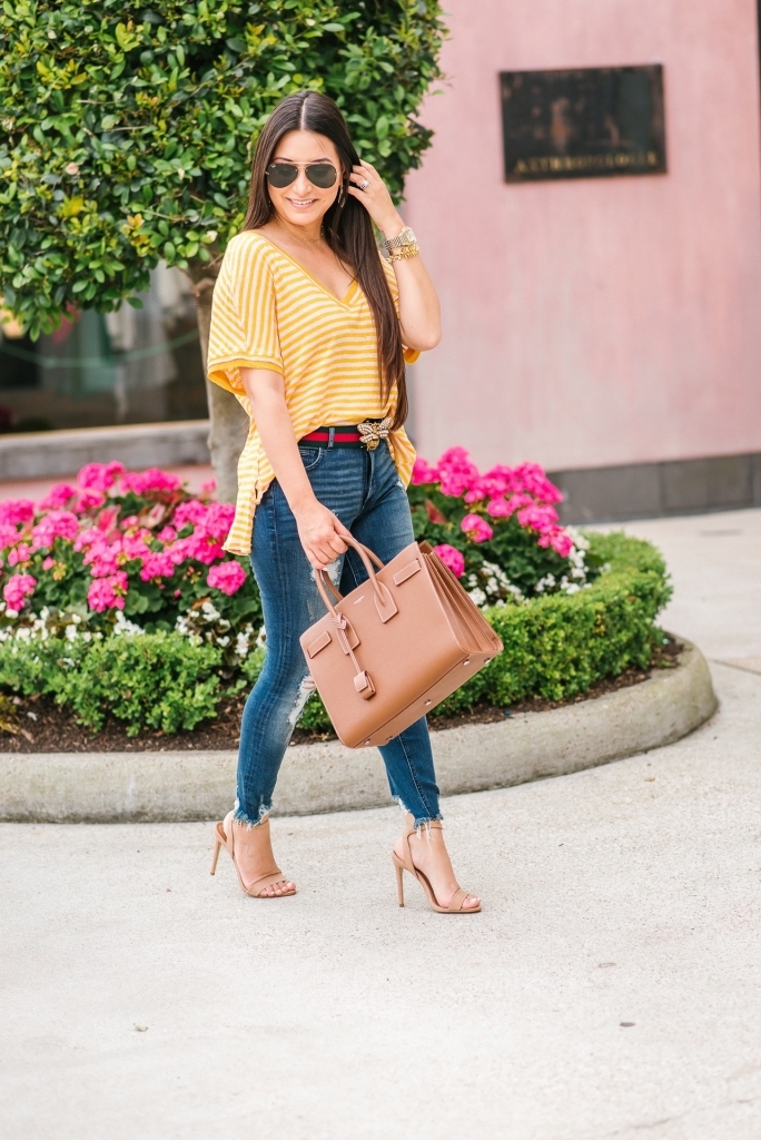 Luxury Handbag Collection and Review featured by top US fashion blog, LuxMommy: image of a woman wearing a Saint Laurent Sac De Jour