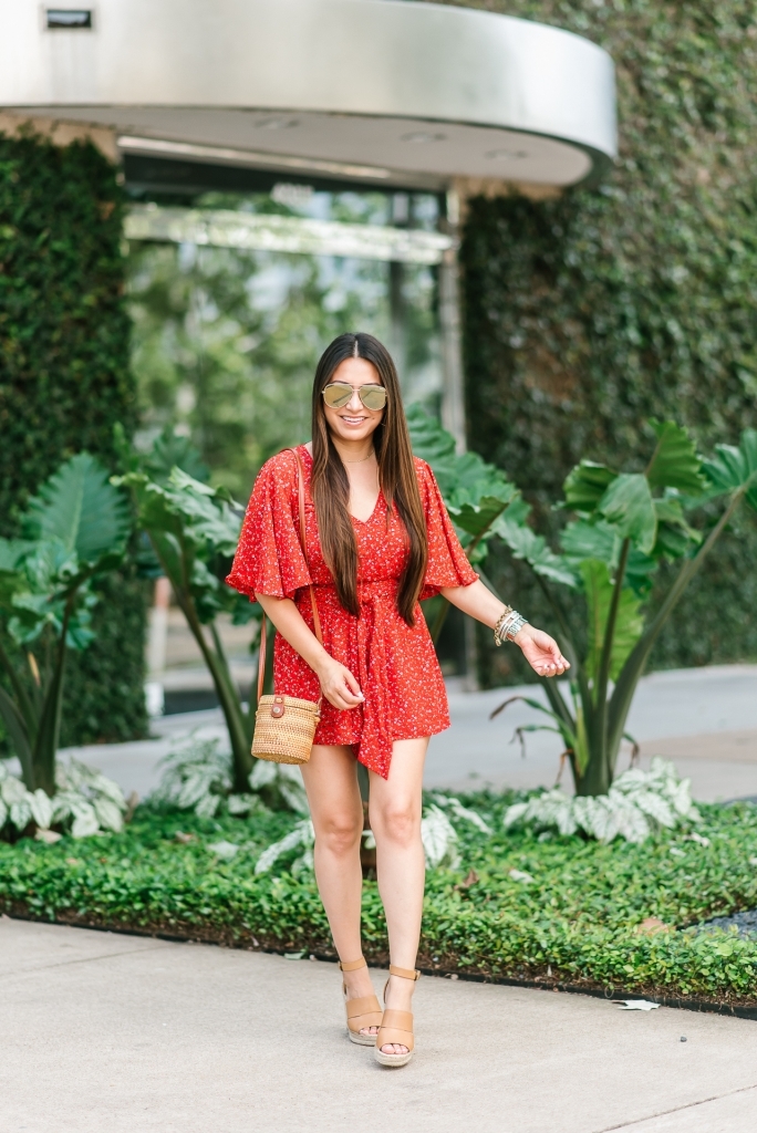 Summer essentials featured by top US fashion blog, LuxMommy: image of a woman wearing a Jack floral romper, Treasure & Bond wedge sandals, Antik Kraft straw bag, Quay Australia aviator sunglasses, Michele diamond watch, David Yurman bracelet, Argento Vivo necklace and Gorjana hoop earrings.