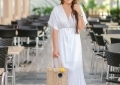 Cute Walmart summer dresses featured by top US fashion blog, LuxMommy: image of a woman wearing an LA Gypsy white maxi dress, Eliza May Rose straw hat, Eliza May Rose pom bag, Michele gold watch, POP fashioner aviator sunglasses and Sam Edelman wedge espadrilles