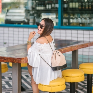 Chanel Gabrielle backpack, White smocked off the shoulder top, quay Jaclyn Hill sunglasses, american eagle midi shorts, Michele watch, stella and dot renegade bracelet, kendra scott charm bracelet, Walmart espadrilles
