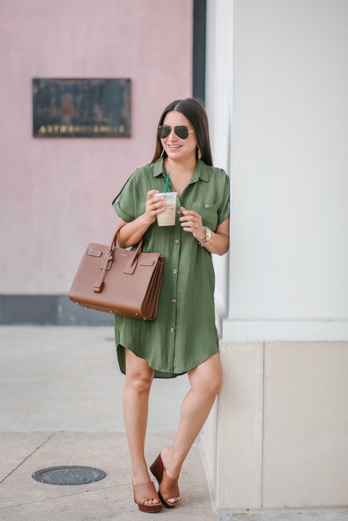 Cute summer shirt dress styled by top US fashion blog, LuxMommy: image of a woman wearing a Red Dress Boutique olive shirt dress, Jessica Simpson wedge sandals, rattan statement earrings, Michele diamond watch, Stella & Dot spike bracelet, Yves Saint Laurent Small Sac de Jour