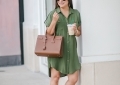 Cute summer shirt dress styled by top US fashion blog, LuxMommy: image of a woman wearing a Red Dress Boutique olive shirt dress, Jessica Simpson wedge sandals, rattan statement earrings, Michele diamond watch, Stella & Dot spike bracelet, Yves Saint Laurent Small Sac de Jour