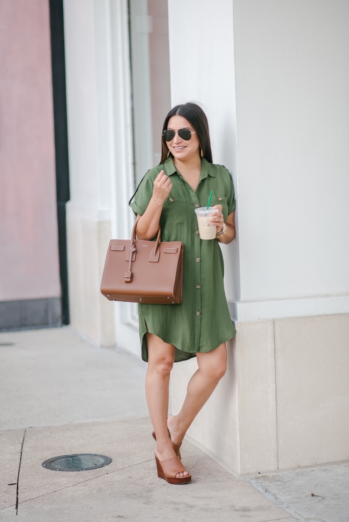 Cute summer shirt dress styled by top US fashion blog, LuxMommy: image of a woman wearing a Red Dress Boutique olive shirt dress, Jessica Simpson wedge sandals, rattan statement earrings, Michele diamond watch, Stella & Dot spike bracelet, Yves Saint Laurent Small Sac de Jour