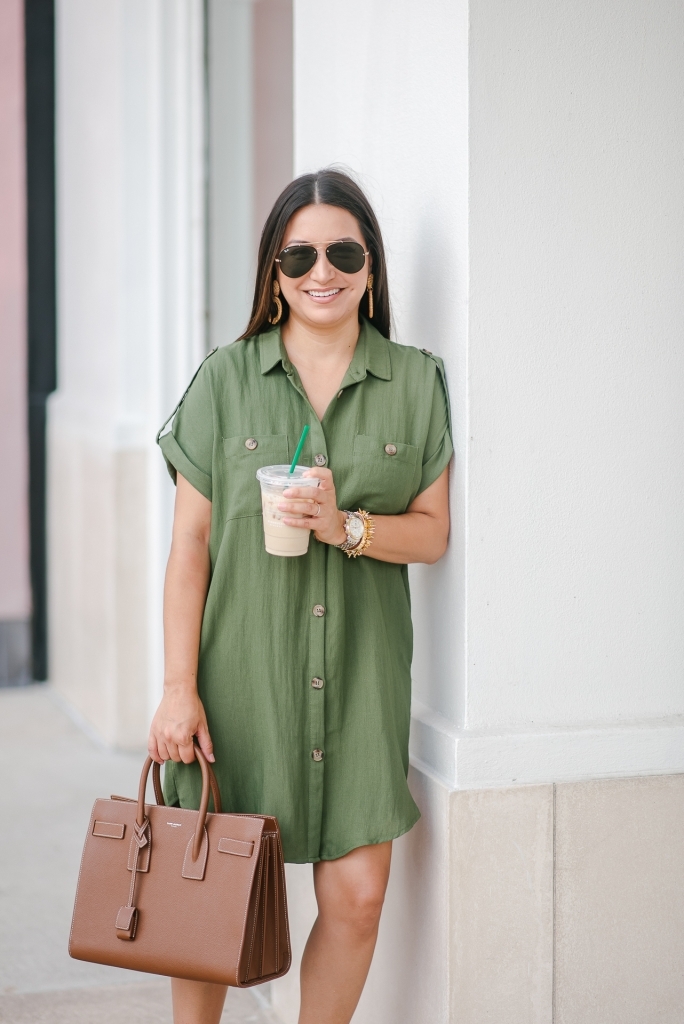 Cute summer shirt dress styled by top US fashion blog, LuxMommy: image of a woman wearing a Red Dress Boutique olive shirt dress, Jessica Simpson wedge sandals, rattan statement earrings, Michele diamond watch, Stella & Dot spike bracelet, Yves Saint Laurent Small Sac de Jour