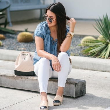 Chanel Gabrielle Backpack review featured by top US fashion blog, LuxMommy: image of a woman wearing a Chanel Gabrielle Backpack, Tory Burch cap toe flat, NYDJ chambray top, Quay Australia studded sunglasses, Michele diamond two tone watch, Stella & Dot bracelet, and a Kendra Scott charm bracelet.