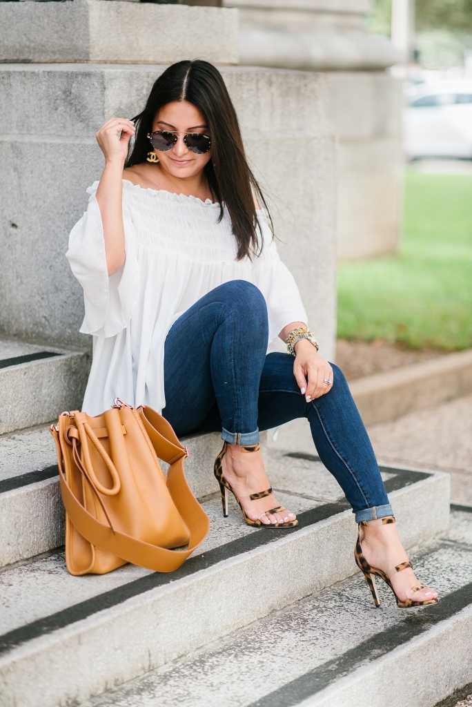 My New Tamara Mellon Handbag and Shoe Obsession by popular Texas fashion blog, Lux Mommy: image a woman sitting on stairs outside and wearing Tamara Mellon leopard print Frontline 105 shoes and a Tamara Mellon Kiss Bag.