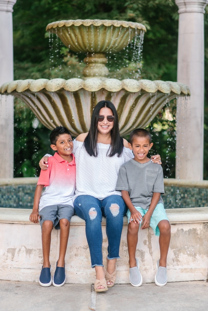 Back to School Style with Walmart by popular Texas fashion blog, Lux Mommy: image of a mom and her two boys sitting on the edge of a courtyard fountain.