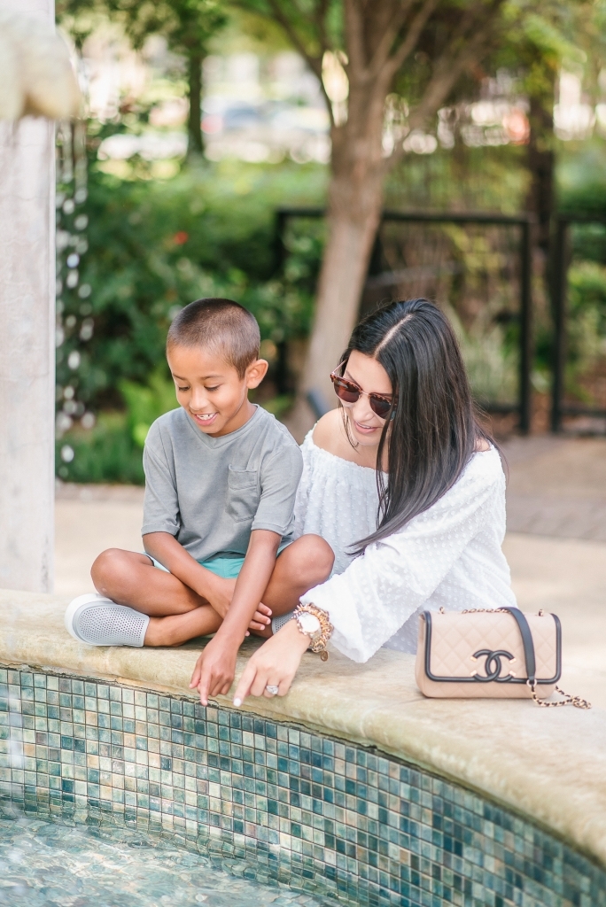 Back to School Style with Walmart by popular Texas fashion blog, Lux Mommy: image of a mom and son looking in to a courtyard fountain.