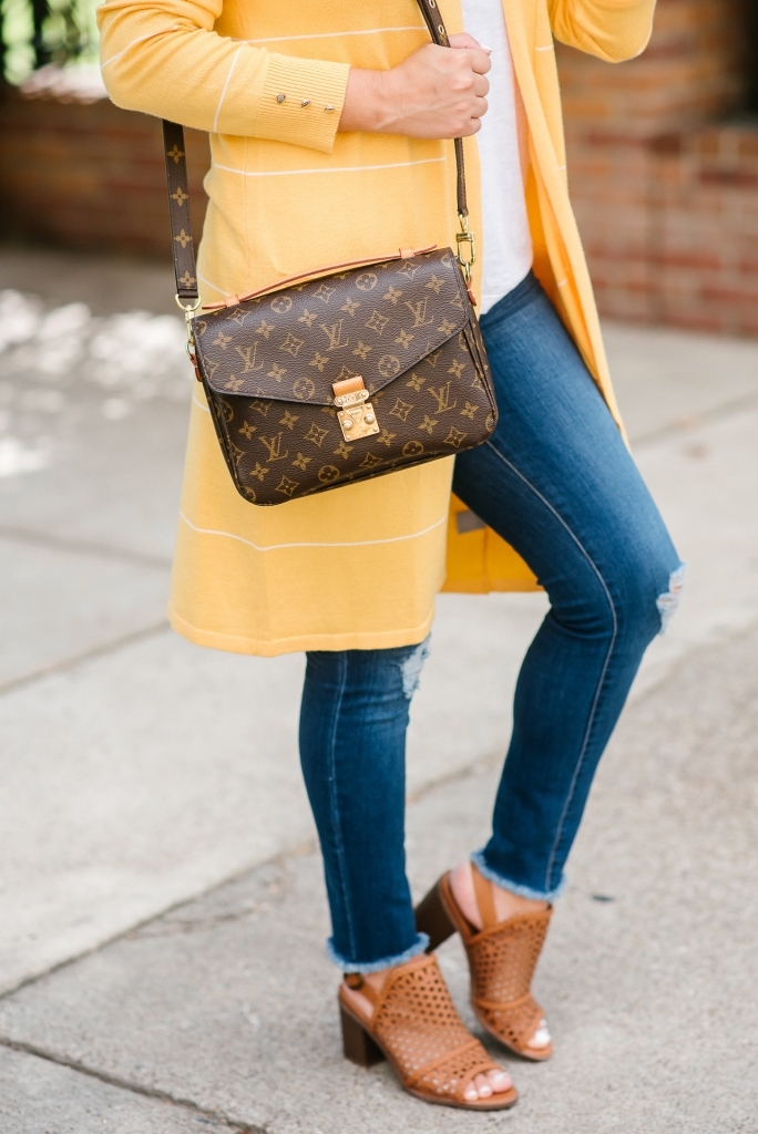 Affordable Fall Transitional Outfit by popular Texas fashion blog, Lux Mommy: image of a woman standing outside and wearing a Walmart Heart N Crush Women's Long Striped Cardigan, Clementine Apparel Women's Deep V-Neck Short Sleeve T-Shirt, Sofia Jeans by Sofia Vergara Sofía Skinny Destructed Mid Rise Ankle Jean Women's (Medium Wash), and Women Big Buddha Woven Peep Toe shoe.