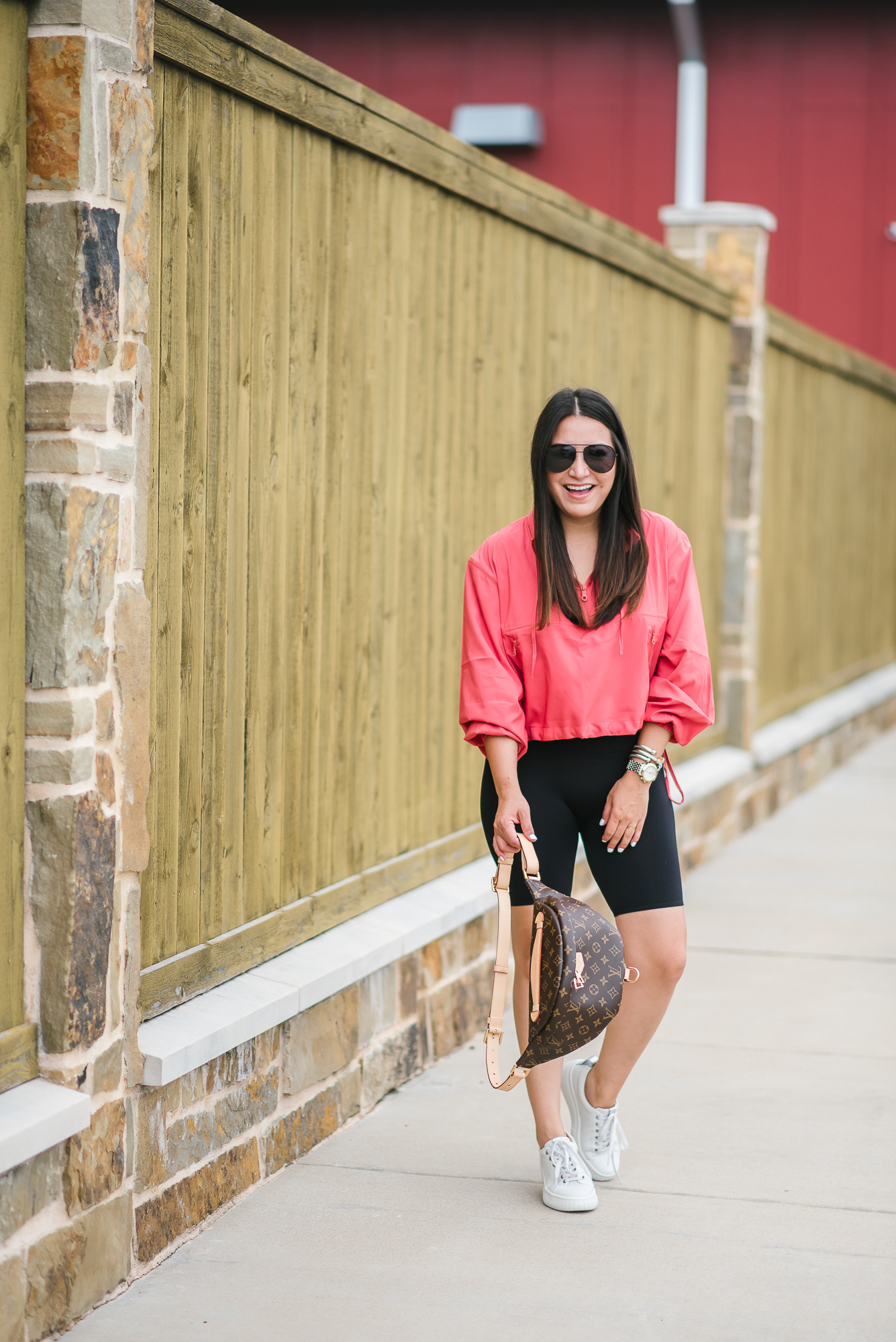 Houston top fashion blogger, LuxMommy, wears a cropped windbreaker, spanx bike shorts, Louis Vuitton bumbag and sneakers