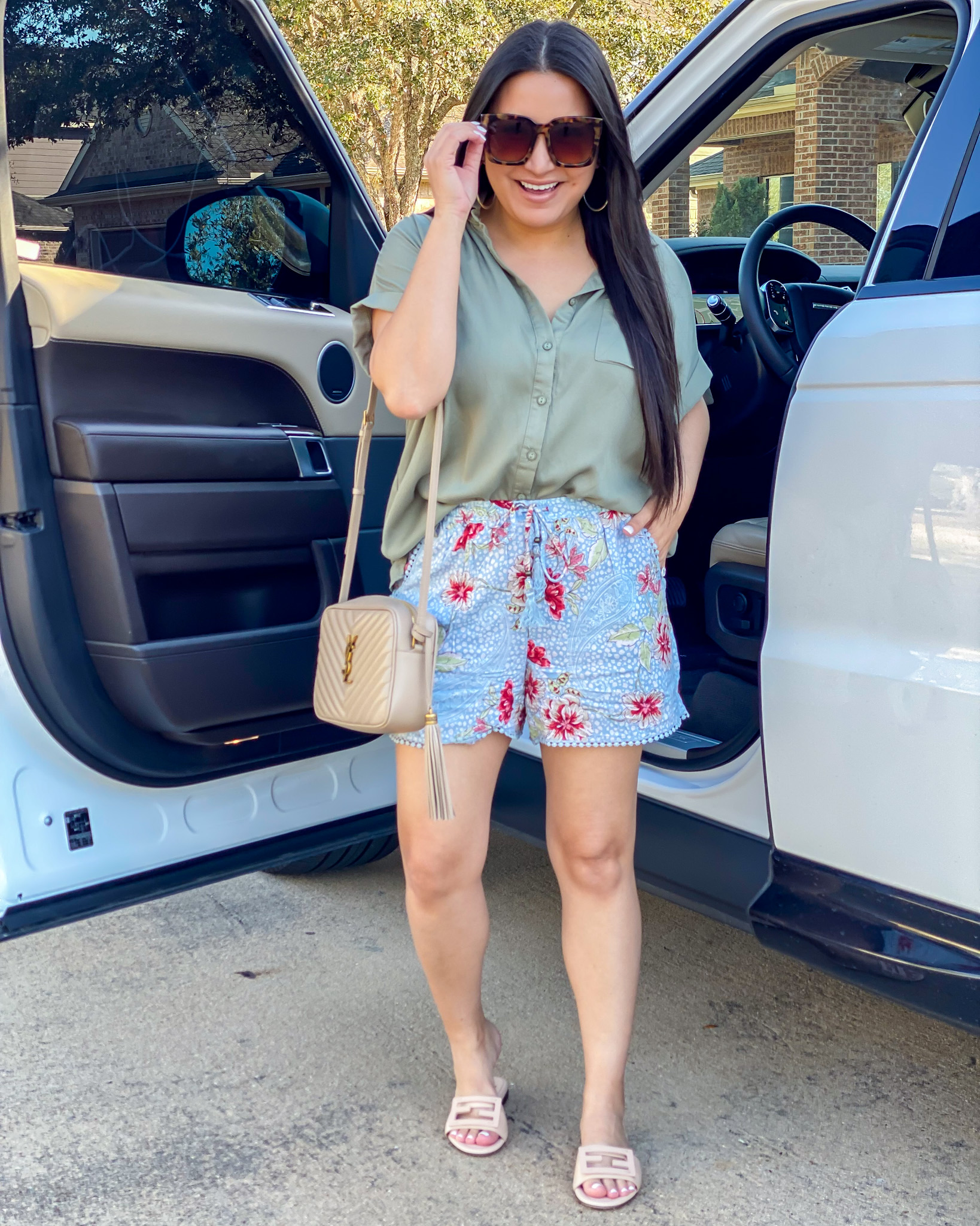Houston top fashion and lifestyle blogger LuxMommy styles floral print shorts, button up top, Fendi sandals, and YSL camera bag