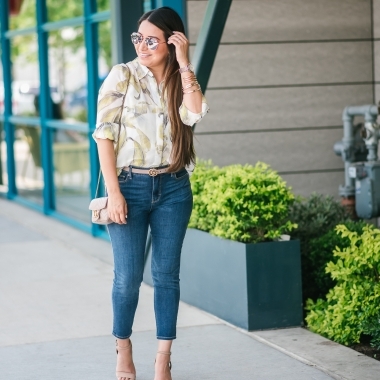White House Black Market Summer Collection Favorites featured by top US fashion blog, LuxMommy: image of a woman wearing a White House Black Market leaf button down shirt, high rise skinny crop jeans, aviator sunglasses, hoop earrings, bangle bracelets, and cuff bracelet