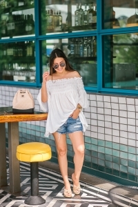 Chanel Gabrielle backpack, White smocked off the shoulder top, quay Jaclyn Hill sunglasses, american eagle midi shorts, Michele watch, stella and dot renegade bracelet, kendra scott charm bracelet, Walmart espadrilles