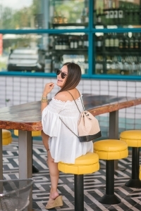 Chanel Gabrielle backpack, White smocked off the shoulder top, quay Jaclyn Hill sunglasses, american eagle midi shorts, Michele watch, stella and dot renegade bracelet, kendra scott charm bracelet, Walmart espadrilles